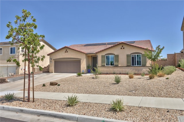 33084 Toledo Bend Ct, Winchester, CA 92596 - mediterranean / spanish-style home with stucco siding, driveway, a garage, a tiled roof, and solar panels