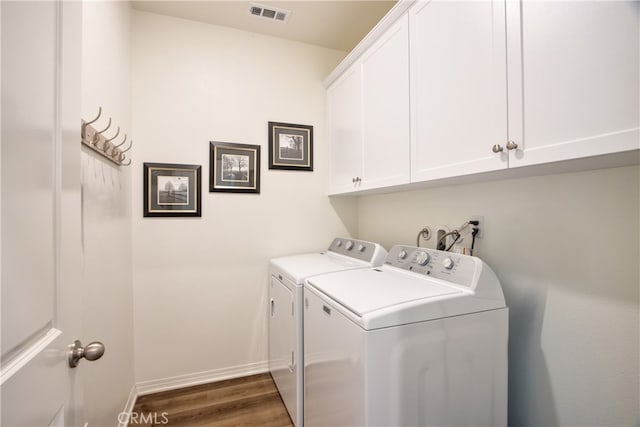 33084 Toledo Bend Ct, Winchester, CA 92596 - laundry room with washing machine and clothes dryer, cabinet space, and dark wood finished floors