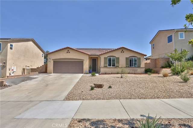 33084 Toledo Bend Ct, Winchester, CA 92596 - mediterranean / spanish house featuring stucco siding, an attached garage, roof mounted solar panels, driveway, and a tiled roof
