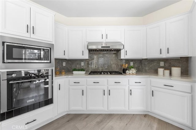 18680 Vantage Pointe Dr, Rowland Heights, CA 91748 - kitchen with appliances with stainless steel finishes, under cabinet range hood, white cabinets, and light countertops