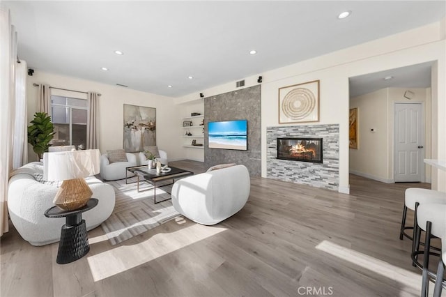 18680 Vantage Pointe Dr, Rowland Heights, CA 91748 - living area featuring recessed lighting, wood finished floors, a tiled fireplace, and built in shelves