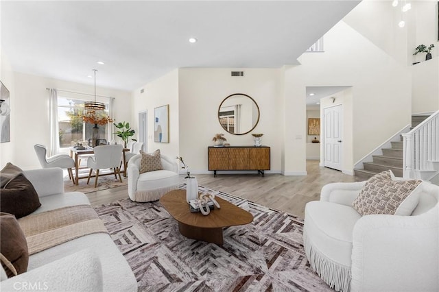 18680 Vantage Pointe Dr, Rowland Heights, CA 91748 - living room with stairs, light wood finished floors, a chandelier, and recessed lighting