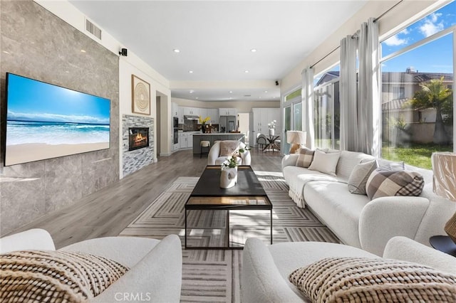 18680 Vantage Pointe Dr, Rowland Heights, CA 91748 - living room with wood finished floors, a fireplace, and recessed lighting