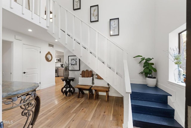 2100 Valley Meadow Dr, Oak View, CA 93022 - staircase featuring hardwood / wood-style flooring, healthy amount of natural light, recessed lighting, and a high ceiling