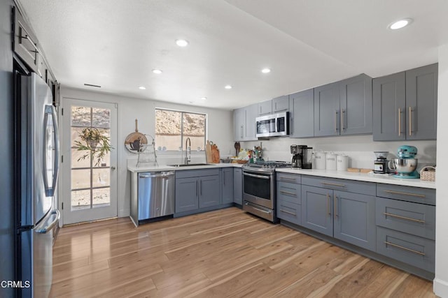 2100 Valley Meadow Dr, Oak View, CA 93022 - kitchen featuring appliances with stainless steel finishes, light countertops, light wood finished floors, recessed lighting, and gray cabinetry