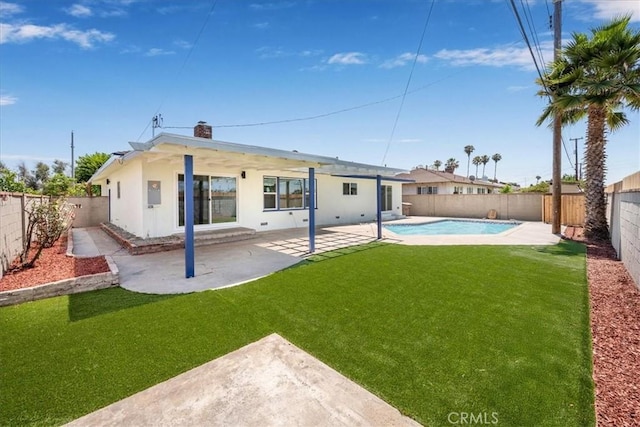 11251 Bowles Ave, Garden Grove, CA 92841 - back of house featuring a fenced backyard, a patio, stucco siding, and a chimney