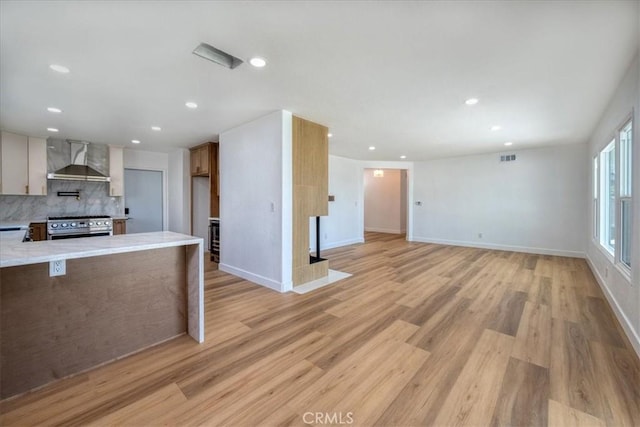 11251 Bowles Ave, Garden Grove, CA 92841 - kitchen featuring wall chimney exhaust hood, stainless steel range with gas cooktop, backsplash, light countertops, and recessed lighting