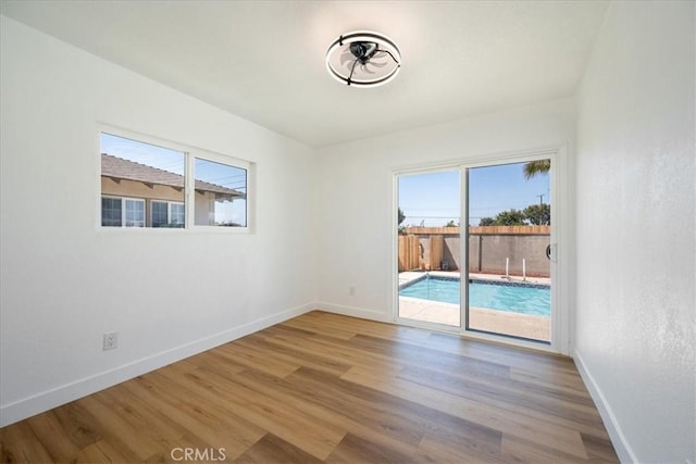 11251 Bowles Ave, Garden Grove, CA 92841 - unfurnished room with healthy amount of natural light and wood finished floors
