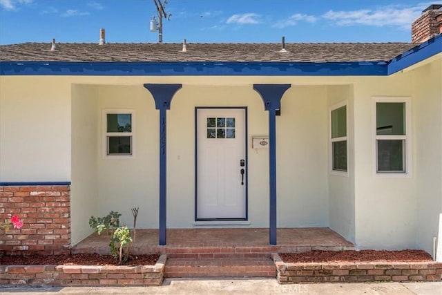 11251 Bowles Ave, Garden Grove, CA 92841 - entrance to property with stucco siding, a shingled roof, and covered porch