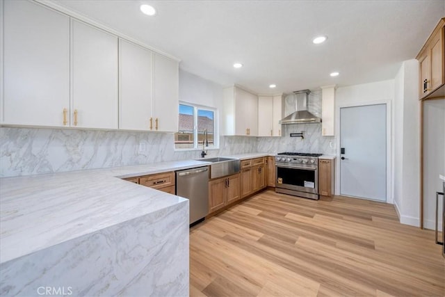11251 Bowles Ave, Garden Grove, CA 92841 - kitchen featuring appliances with stainless steel finishes, wall chimney range hood, light wood-style flooring, tasteful backsplash, and recessed lighting