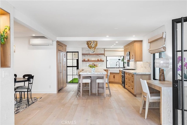 1817 W Bay Ave Unit A, Newport Beach, CA 92663 - kitchen with a wall unit AC, gas range, open shelves, light countertops, and recessed lighting