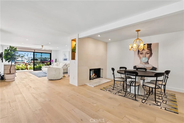 1817 W Bay Ave Unit A, Newport Beach, CA 92663 - dining space with wood finished floors, recessed lighting, a tile fireplace, and a chandelier