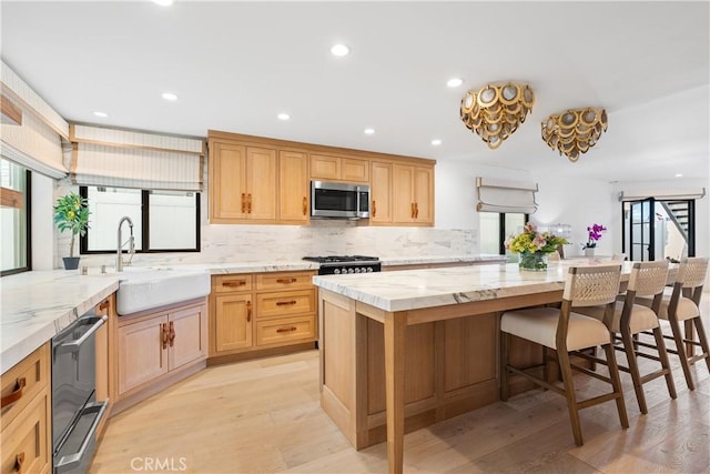 1817 W Bay Ave Unit A, Newport Beach, CA 92663 - kitchen featuring stainless steel microwave, black dishwasher, plenty of natural light, light wood-style flooring, and recessed lighting