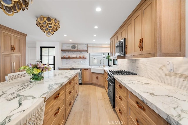 1817 W Bay Ave Unit A, Newport Beach, CA 92663 - kitchen featuring appliances with stainless steel finishes, light wood finished floors, decorative backsplash, recessed lighting, and light stone countertops