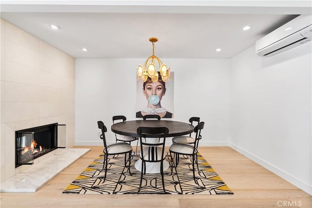 1817 W Bay Ave Unit A, Newport Beach, CA 92663 - dining area featuring a wall mounted air conditioner, light wood finished floors, a chandelier, recessed lighting, and a fireplace
