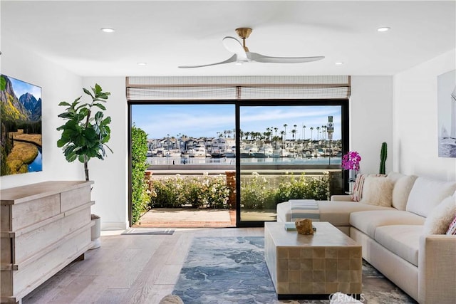 1817 W Bay Ave Unit A, Newport Beach, CA 92663 - living room with expansive windows, a ceiling fan, wood finished floors, a water view, and recessed lighting