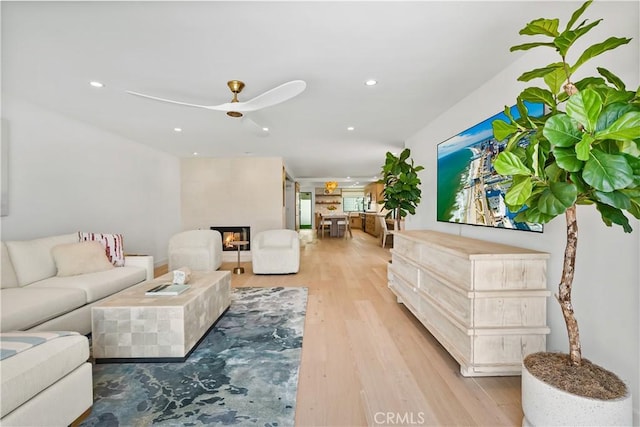 1817 W Bay Ave Unit A, Newport Beach, CA 92663 - living area featuring ceiling fan, a warm lit fireplace, recessed lighting, and light wood-style flooring