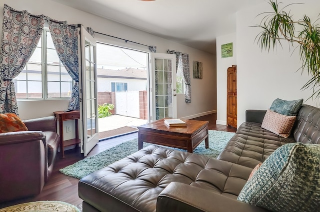 12826 Bombardier Ave, Norwalk, CA 90650 - living room with dark wood-style flooring and baseboards