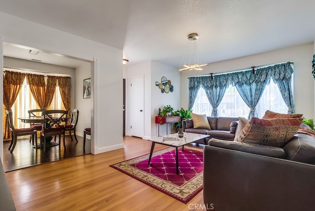 12826 Bombardier Ave, Norwalk, CA 90650 - living room with light wood-type flooring and baseboards