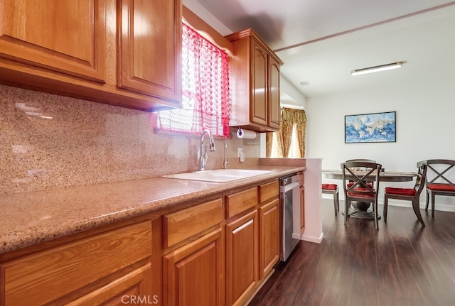 12826 Bombardier Ave, Norwalk, CA 90650 - kitchen featuring dark wood-style floors, decorative backsplash, stainless steel dishwasher, and brown cabinetry