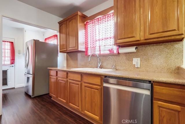 12826 Bombardier Ave, Norwalk, CA 90650 - kitchen with appliances with stainless steel finishes, dark wood finished floors, decorative backsplash, and plenty of natural light
