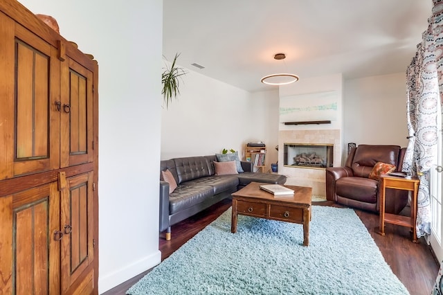 12826 Bombardier Ave, Norwalk, CA 90650 - living room with dark wood finished floors and a tiled fireplace