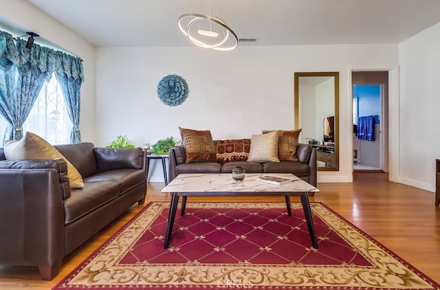 12826 Bombardier Ave, Norwalk, CA 90650 - living room with light wood-style floors and baseboards