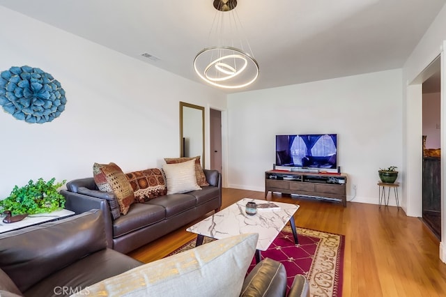 12826 Bombardier Ave, Norwalk, CA 90650 - living room with a chandelier and wood finished floors