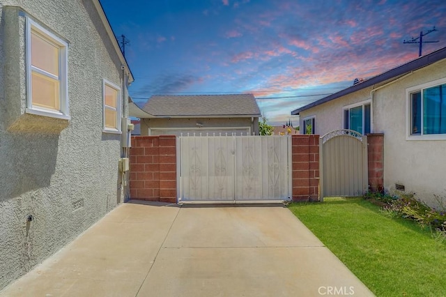 12826 Bombardier Ave, Norwalk, CA 90650 - yard at dusk with a gate and a garage