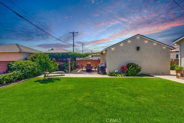 12826 Bombardier Ave, Norwalk, CA 90650 - yard at dusk featuring a patio