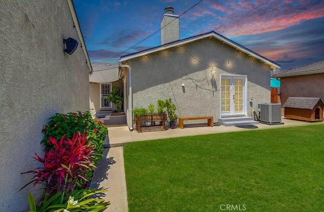 12826 Bombardier Ave, Norwalk, CA 90650 - rear view of property with french doors, stucco siding, a yard, and a chimney