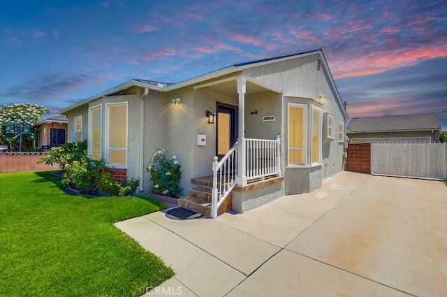 12826 Bombardier Ave, Norwalk, CA 90650 - view of front of house featuring stucco siding, driveway, and a garage