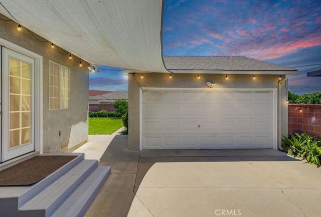 12826 Bombardier Ave, Norwalk, CA 90650 - garage at dusk featuring driveway
