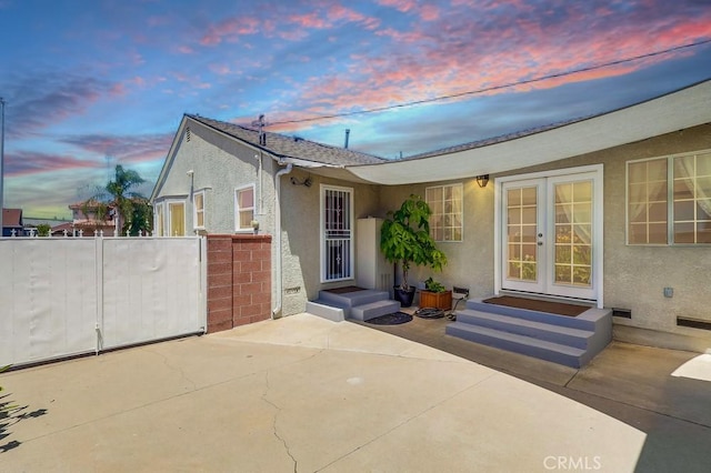 12826 Bombardier Ave, Norwalk, CA 90650 - view of front facade featuring stucco siding, a patio area, and french doors