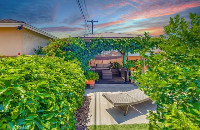 12826 Bombardier Ave, Norwalk, CA 90650 - patio terrace at dusk featuring a patio area and an outdoor living space