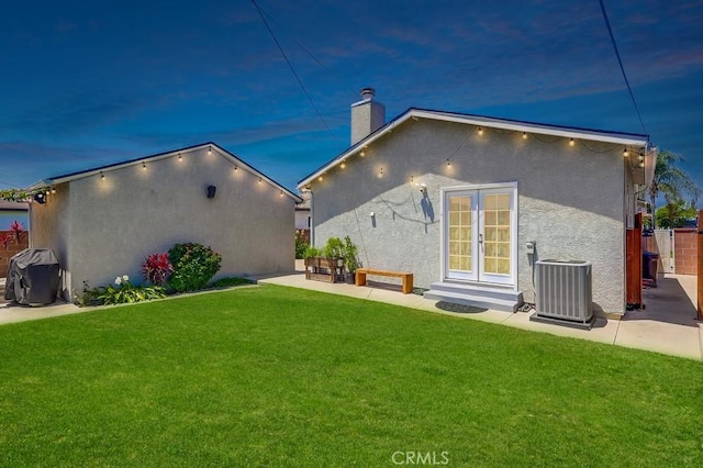 12826 Bombardier Ave, Norwalk, CA 90650 - rear view of house featuring a chimney, stucco siding, a patio, and french doors