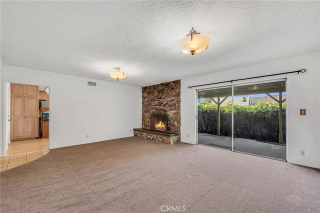 13624 Vose St, Valley Glen, CA 91405 - unfurnished living room featuring carpet, a stone fireplace, and a textured ceiling