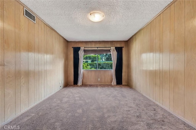 13624 Vose St, Valley Glen, CA 91405 - spare room featuring carpet, wood walls, and a textured ceiling