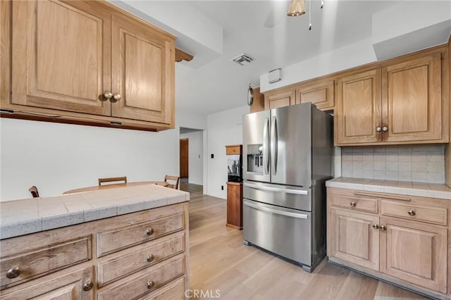 13624 Vose St, Valley Glen, CA 91405 - kitchen with stainless steel refrigerator with ice dispenser, tile counters, light wood finished floors, and tasteful backsplash