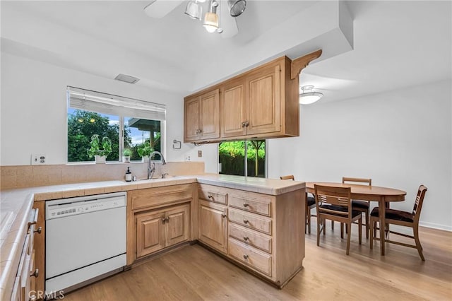 13624 Vose St, Valley Glen, CA 91405 - kitchen with white dishwasher, ceiling fan, tile countertops, light wood-style floors, and a peninsula