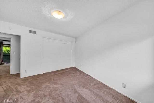13624 Vose St, Valley Glen, CA 91405 - unfurnished bedroom with carpet flooring, a textured ceiling, and a closet