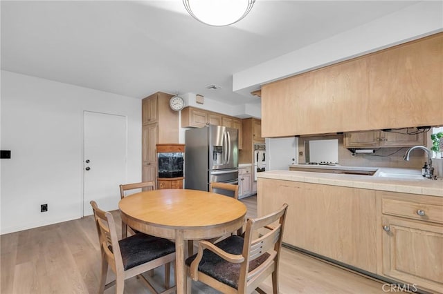 13624 Vose St, Valley Glen, CA 91405 - dining space featuring light wood-style floors and baseboards
