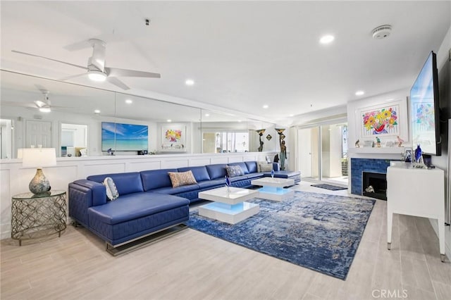 200 Pacific Coast Unit 130, Huntington Beach, CA 92648 - living room featuring light wood-style floors, a tile fireplace, a ceiling fan, and recessed lighting