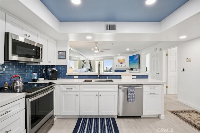 200 Pacific Coast Unit 130, Huntington Beach, CA 92648 - kitchen with appliances with stainless steel finishes, a ceiling fan, white cabinetry, light countertops, and recessed lighting