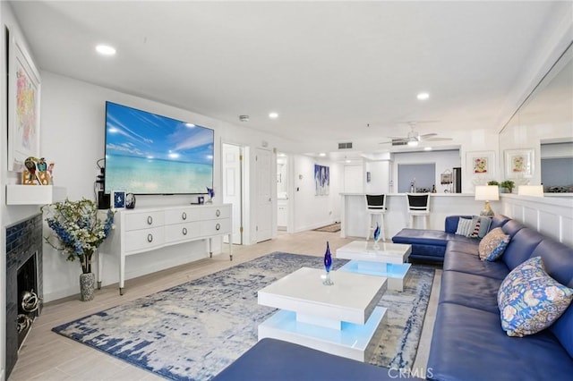 200 Pacific Coast Unit 130, Huntington Beach, CA 92648 - living area featuring a ceiling fan, a fireplace, recessed lighting, and light wood-style flooring
