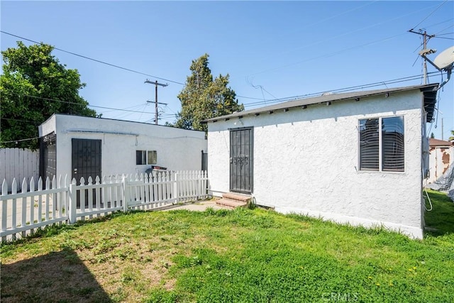 11001 Duncan Ave, Lynwood, CA 90262 - rear view of house featuring stucco siding and entry steps