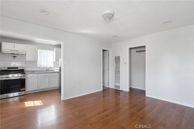11001 Duncan Ave, Lynwood, CA 90262 - kitchen with stainless steel appliances, a heating unit, under cabinet range hood, wood finished floors, and a textured ceiling