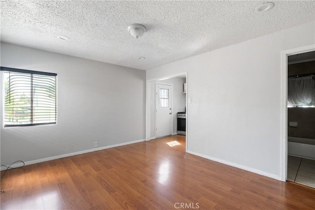 11001 Duncan Ave, Lynwood, CA 90262 - unfurnished room featuring wood finished floors and a textured ceiling