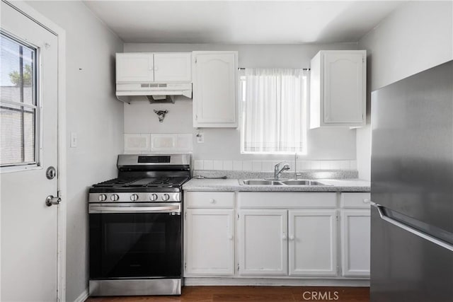 11001 Duncan Ave, Lynwood, CA 90262 - kitchen featuring stainless steel appliances, under cabinet range hood, white cabinets, and light countertops