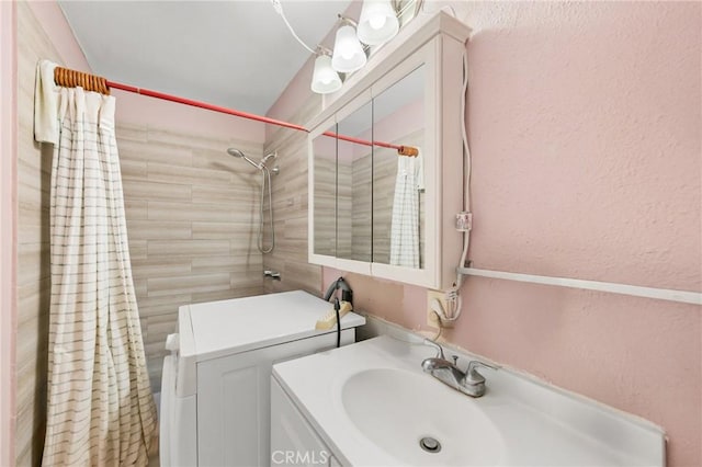 213 S Atlantic Blvd, Alhambra, CA 91801 - bathroom featuring vanity, tiled shower, and a textured wall